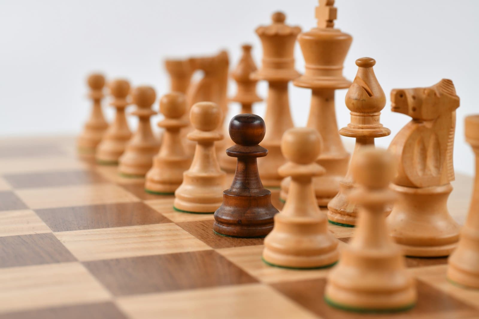 Chess pieces facing off on a board, symbolizing the money app match-up